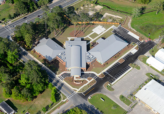 The Kearney Center in Tallahassee, FL, features curved rafters with a hip roof tie-in using a 16-inch vertical leg standing seam roof.